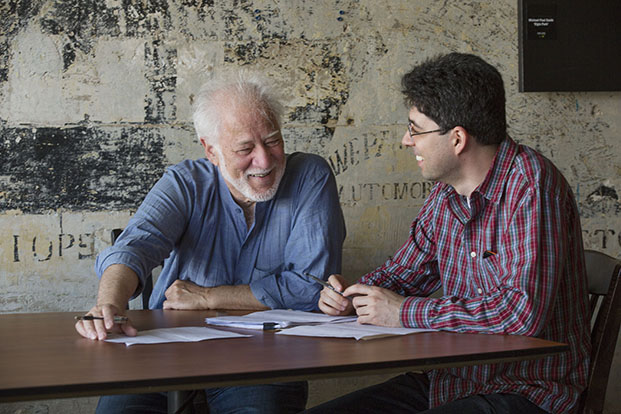 Mentor Michael Ondaatje (left) and protégé Miroslav Penkov discuss Penkov's manuscript for his novel.